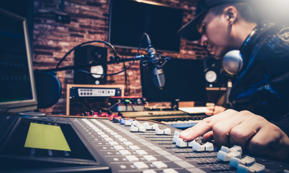 music producer working on sound mixer in recording studio or DJ music producer working on sound mixer in recording studio or DJ